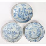 Three 18th Century Delft plates, each depicting an Oriental scenes within landscapes, 21cm