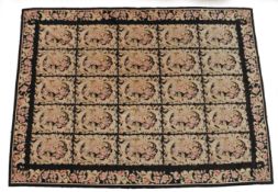 A European needlework rug, with five rows of foliate panels, 240cm x 325cm