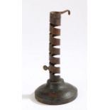 A 19th Century French wrought iron and wood candlestick, circa 1800, with a stem formed of a