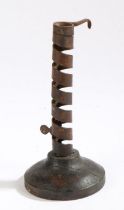 A 19th Century French wrought iron and wood candlestick, circa 1800, with a stem formed of a