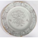 A mid 18th Century English Delft charger, circa 1760, with purple flower design to the centre and