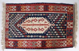 An Anatolian Slit weave Kilim, with a central motif on a cream ground surrounded by a field of