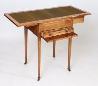 A Regency rosewood and satinwood writing table, the hinged top enclosing a felt writing surface