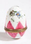 A 19th Century enamel egg, in white and pink with floral sprays, gilt metal screw collar, dent, 45mm
