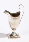 A George III silver cream jug, London 1790, maker Peter & Ann Bateman, of helmet form with loop