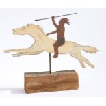 A 20th century Folk art naïve wooden cut out of a native American on horse back set on a wooden