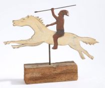 A 20th century Folk art naïve wooden cut out of a native American on horse back set on a wooden