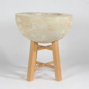 A large cast ceramic bird bath with a dished recess raised on a wooden stand, 60cm high 55cm