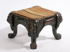 A 19th Century carved dark stained stool, with lion mask and paw feet, the side rails carved with