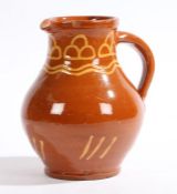 A clay pit pottery Ewenny terracotta jug with wavy and angled line decoration, 22cm high