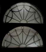 A pair of Georgian wrought iron sectional fan lights, each with new mirrors, 112cm wide (2)