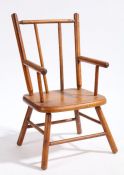 A miniature elbow chair with turned spindle back and arm supports, solid seat, raised on turned legs