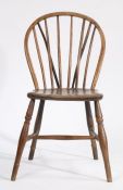 A 19th Century stick back dining chair, the arched cresting rail above turned spindles and a solid