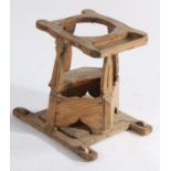 An 18th Century child's walker, the top with open circular recess and tray above four shaped