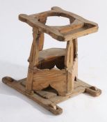 An 18th Century child's walker, the top with open circular recess and tray above four shaped