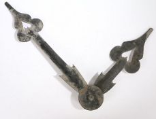A large pair of clock hands, mounted on a circular backing, the minutes hand 83cm long, the hours