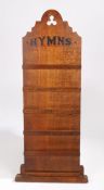 An early 20th century wooden Hymn board, containing four shelves and the top marked 'Hymn's' 81cm