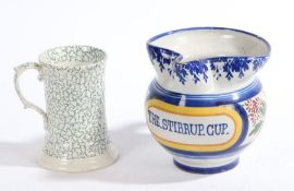 A pottery jug inscribed "THE STIRRUP CUP", 15cm high, together with a porcelain mug with seaweed