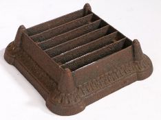 A 19th Century cast iron boot scraper, the slatted top with tapering corners and gadrooned body,