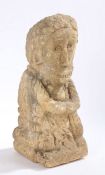 A carved stone statue depicting a figure with broad grin, 40cm high