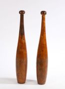 A pair of treen Indian exercise clubs, the rounded terminals stamped "4" above reeded handles and