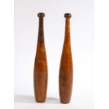 A pair of treen Indian exercise clubs, the rounded terminals stamped "4" above reeded handles and