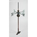 A weathervane, with the four points of the compass symbolised by capital letters, 109cm high, 59cm