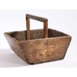 A wooden trug with turned handle and tapering ends, 32cm wide, 26cm deep, 23.5cm high
