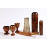 A collection of treen to include three goblets, pestle, smoother, two stands (7)