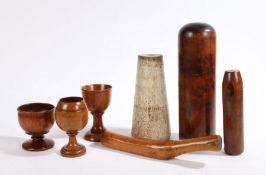 A collection of treen to include three goblets, pestle, smoother, two stands (7)