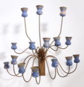 An early 20th Century wall sconce, with fifteen blue thistle form candle sconces, 58cm high, 65cm