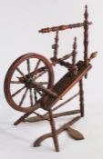 A Victorian spinning wheel, with spindle turned wheel spokes and frame