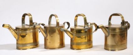 Four Victorian brass watering cans, with hinged lids and loop handles (4)
