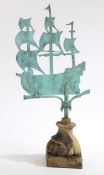 A weathervane modelled as a three masted ship, presented on a gadrooned reconstituted plinth base,