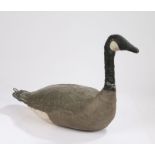 An early 20th Century decoy goose, the canvas body painted white, black and grey and a hook to the