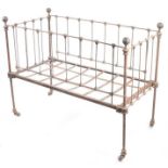A late 19th/early 20th Century child's crib, with white painted metal frame, 123cm wide, 61cm