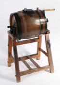 A 19th Century butter churn, with rotating barrel top, raised on a wooden frame, 105cm wide, 114cm