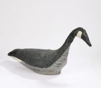 An early 20th Century decoy goose, the canvas body painted white, black and grey with painted