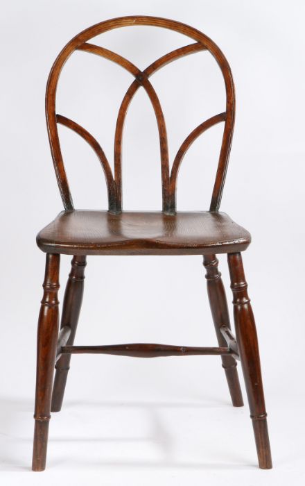 An early 19th century Thames Valley elm and oak Gothic Windsor chair, the hoop back with Gothic