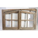 A 19th Century pine window frame, the arched frame with two windows, 141cm wide, 85cm high