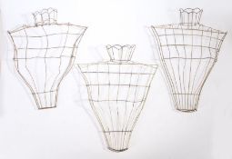 Three wire flower wall pockets modelled as female torsos, 40cm wide, 52cm high (3)