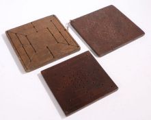 Three 19th Century treen games board, to include a solitaire board and two six men's morris