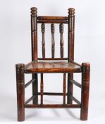 A 19th Century turners or bodgers style chair, with turned cresting rail, splats and supports, solid