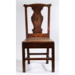 A George III country made oak dining chair, the shaped cresting rail above a vase shaped splat