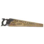 A large painted wooden advertising sign in the form of a saw, inscribed, J H Swift & Sons,