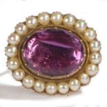 A Victorian amethyst and pearl brooch, with a central facetted oval foil backed amethyst and pearl