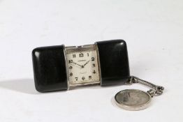 A Movado Chronometre Ermeto silver purse watch, the polished black case opening to reveal a signed