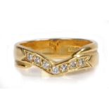 An 18 carat gold diamond set ring, the arched head containing seven diamonds, inscription to the