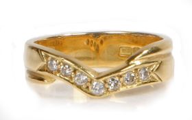 An 18 carat gold diamond set ring, the arched head containing seven diamonds, inscription to the