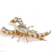 A moonstone set scorpion brooch, with cabochon cut moonstone to the body, tall and claws, 42mm long,